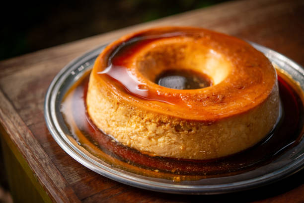 istock Brazilian gastronomy. Milk pudding with caramelized syrup on wooden table. 1262026174