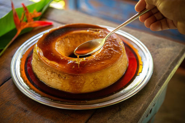 istock Brazilian gastronomy. Milk pudding with caramelized syrup on wooden table. 1262026209