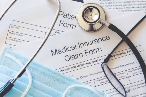 medical insurance claim form with stethoscope and surgical face mask. - health insurance imagens e fotografias de stock