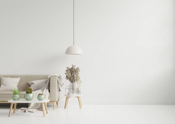 istock Empty living room with brown color sofa/ornamental glass jar and table on empty white wall background. 1262027797