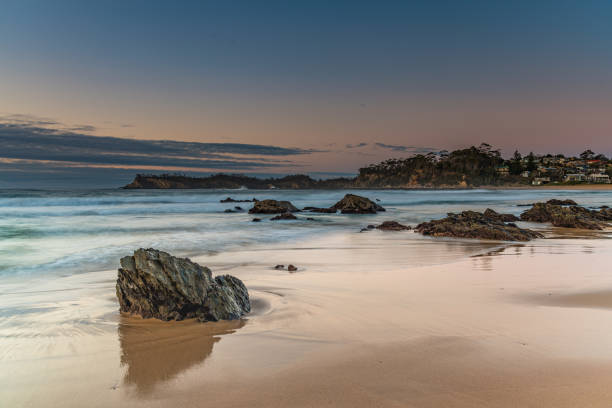 istock Sunrise at the beach with rocks and low cloud bank 1262043252