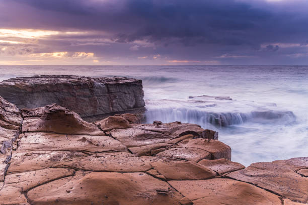 istock Rain clouds, rock platform and cascades sunrise seascape 1262043863