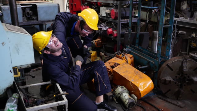 Colleagues are going to help workers who are injured from industrial machinery.