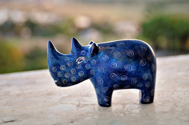 istock A decorative blue stone mini rhinoceros in late afternoon 1262061528