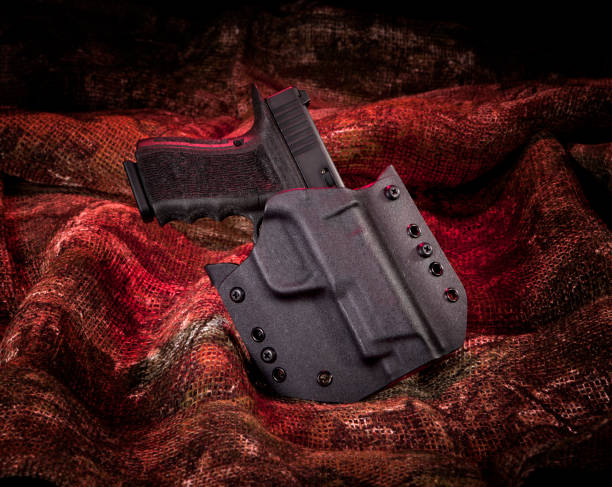 istock Pistol in holster on fur background. 1262078232