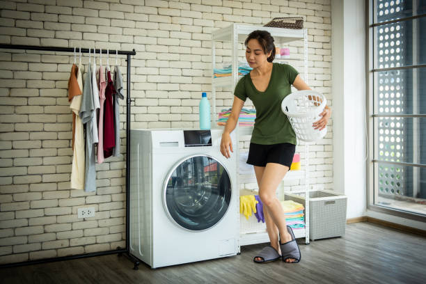 istock Young woman doing laundry at home. 1262086651