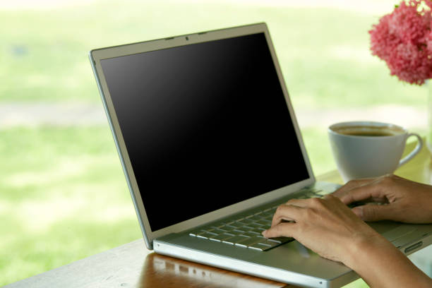 Closeup woman sitting at home office using laptop