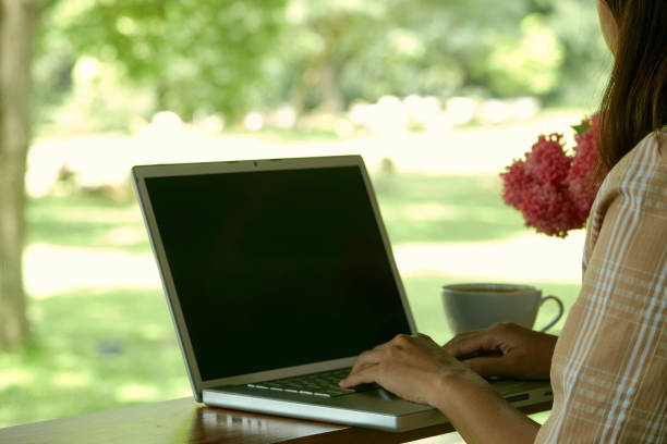 istock Closeup woman sitting at home office using laptop 1262086836