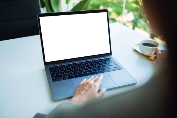 istock a businesswoman using and touching on laptop touchpad with blank white desktop screen while drinking coffee in office 1262092711