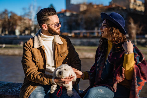 istock Couple with dog enjoying on riverbank 1262097244