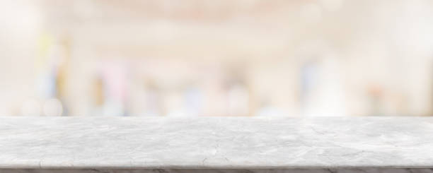 istock Empty white marble stone table top and blur glass window interior restaurant banner mock up abstract background - can used for display or montage your products. 1262099947
