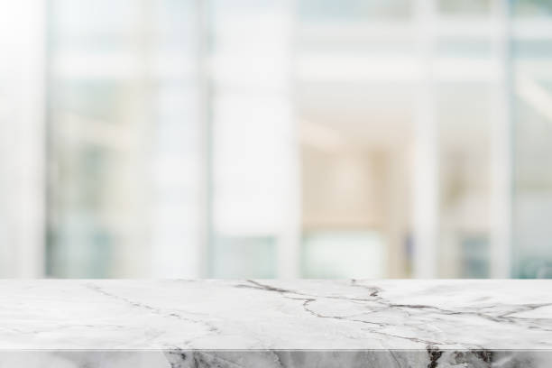 istock Empty white marble stone table top and blur glass window interior restaurant banner mock up abstract background - can used for display or montage your products. 1262099959