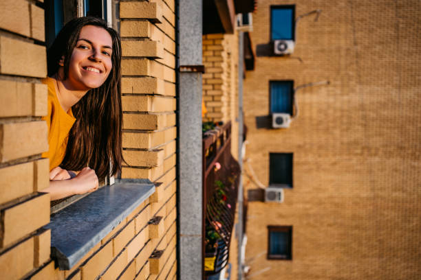 istock Woman enjoying in sun at window 1262108587