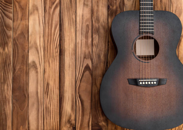 istock Acoustic guitar on wooden background. Space for text. 1262115864