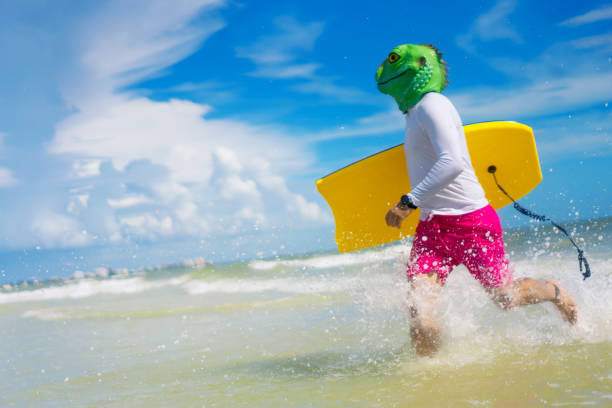 istock Man wearing a lizard mask in the beach 1262120067