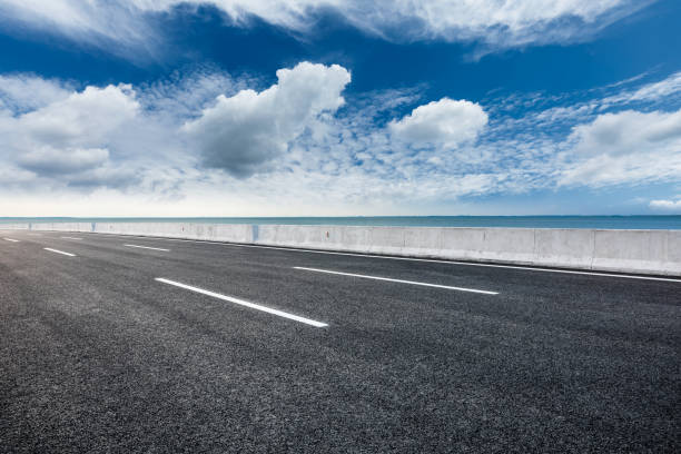 istock Asphalt road and beautiful sky with river. 1262126551