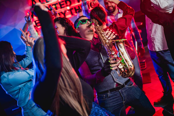 istock Saxophonist on club party 1262131451