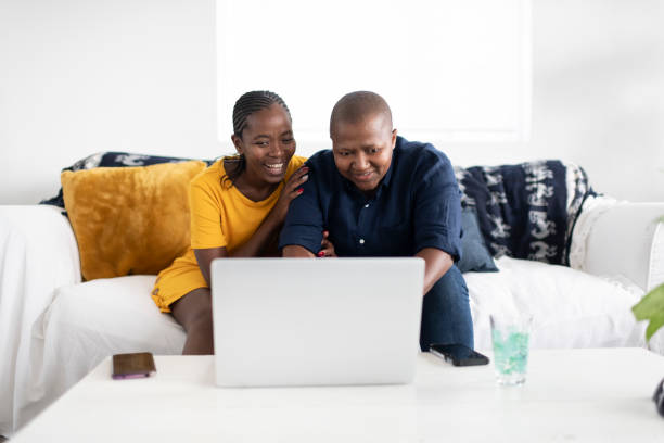 istock Couple booking holiday online together 1262132538