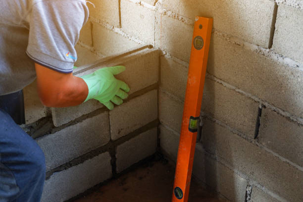 hand with gestures man bricklayer is catch cement brick block for To get straight In the wall construction. sign human hand pointing manual worker stock pictures, royalty-free photos & images