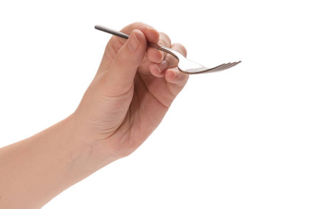 istock Fork in woman hand isolated on white. 1262154179