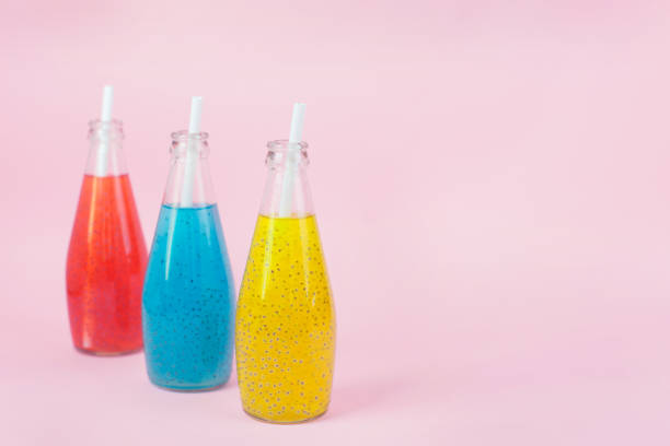istock Basil Seed Drink in glass Bottles on pink background 1262154954