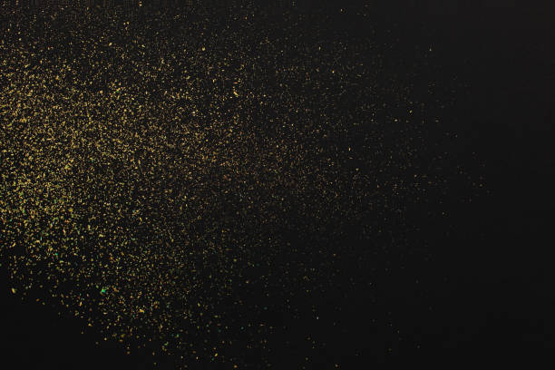 istock Gold glitter on black background. Holiday abstract texture 1262154972
