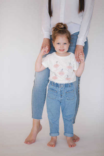 istock Little girl with mom in studio. White background 1262167994