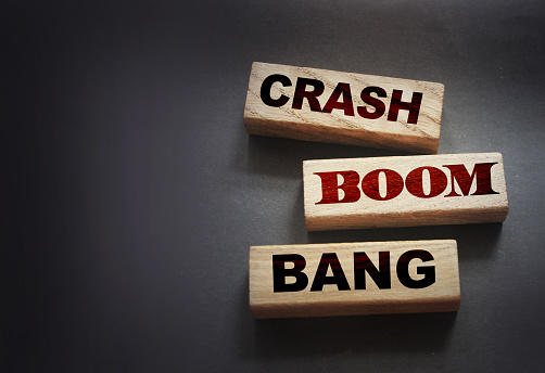 Crash boom bang words on wooden blocks on black background. Unexpected crisis, failure or bankruptcy business concept. End of relationship concept.