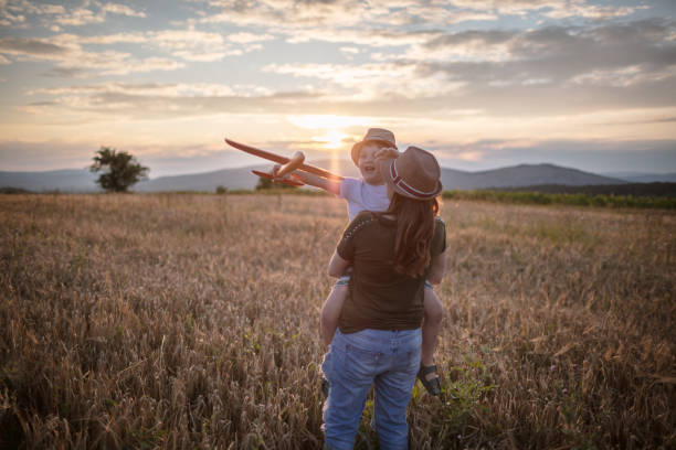 istock Boy playing with airplane with mum 1262189568