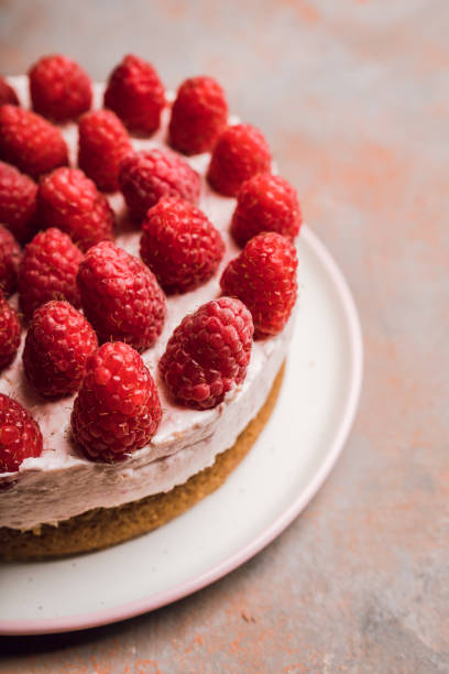 istock Fresh cheesecake with raspberries on the rustic background 1262189604