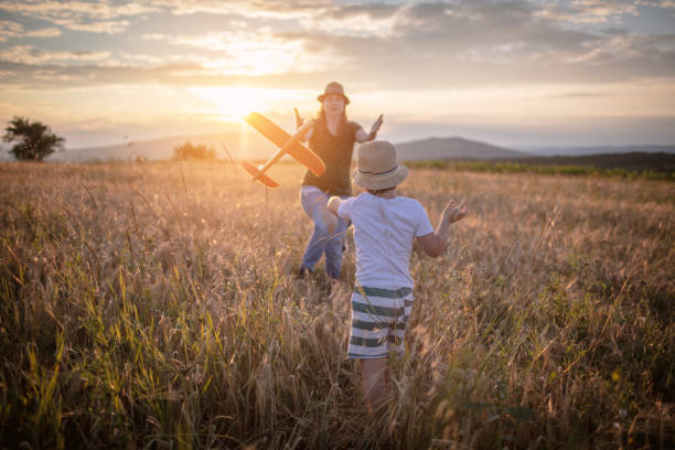 istock Boy playing with airplane with mum 1262189857