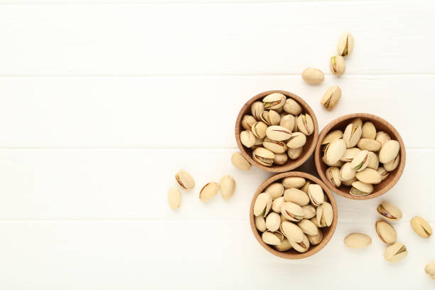 istock Pistachios in bowls on white wooden table 1262196282