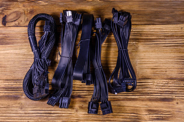 istock Set of computer psu cables on a wooden background 1262197224