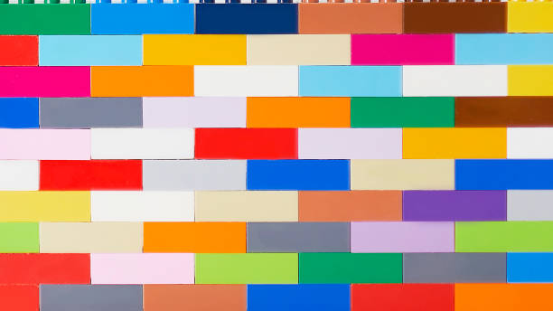 istock plastic building block. plastic brick wall. Wall from Plastic building blocks isolated. Suitable for greetings card, holidays. White background. Rainbow colors 1262198444