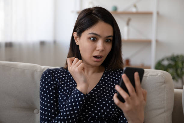istock Shocked Vietnamese girl surprised by message on cellular 1262199064