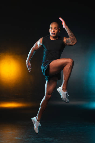 istock Handsome sporty man leaping and looking into the distance 1262199817