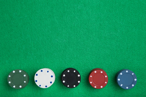istock Stacks of poker chips on green table 1262200877
