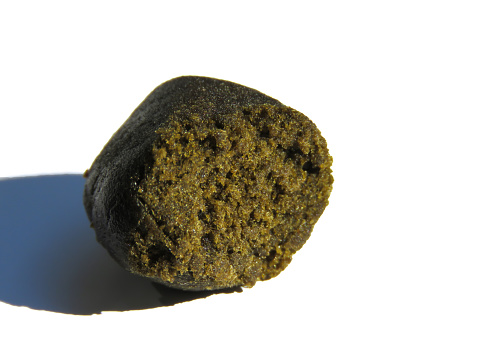 Piece of hashish, hash, resin of the cannabis, isolated on white background.