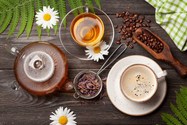 Herbal tea and espresso coffee Herbal tea in teapot and cup and espresso coffee on wooden table. Top view. Flat lay tea crop stock pictures, royalty-free photos & images