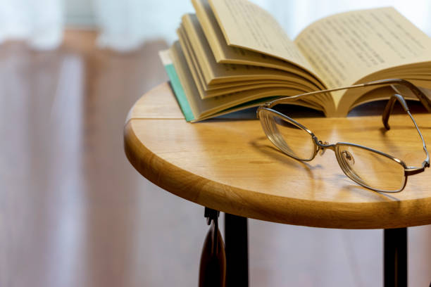 istock Glasses and book placed on the table 1262217372