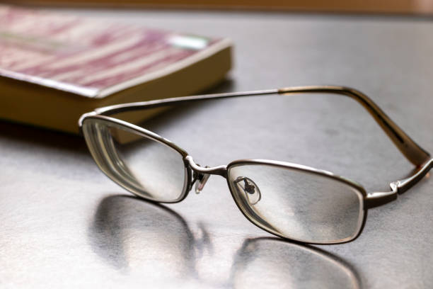 istock Glasses and book placed on the table 1262217373