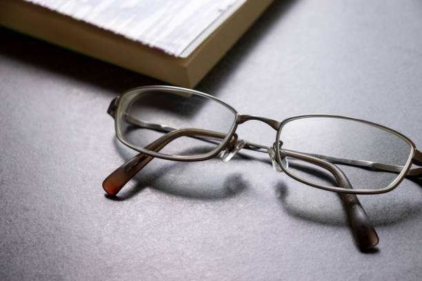 istock Glasses and book placed on the table 1262217375