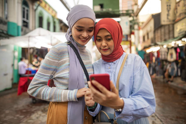istock Asian women sightseeing and using phone at town 1262218248