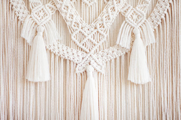 istock Close-up of hand made macrame texture pattern.  ECO friendly modern knitting DIY natural decoration concept  in the interior. Flat lay. Handmade macrame 100% cotton. Details close up. Female hobby. 1262231513