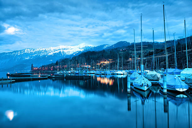 湖に浮かぶボートトゥーンます。 - lake thun switzerland night lake ストックフォトと画像