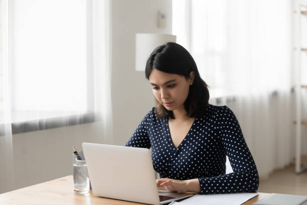 istock Focused Vietnamese girl work on laptop at home 1262241404