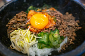 Bibimbap is rice topped with namul(seasoned vegetables) and meat, and gochujang or other sauce. The toppings are usually stirred together with the rice before eating.
