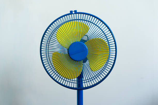 istock A colorful blue and yellow standing fan 1262251115