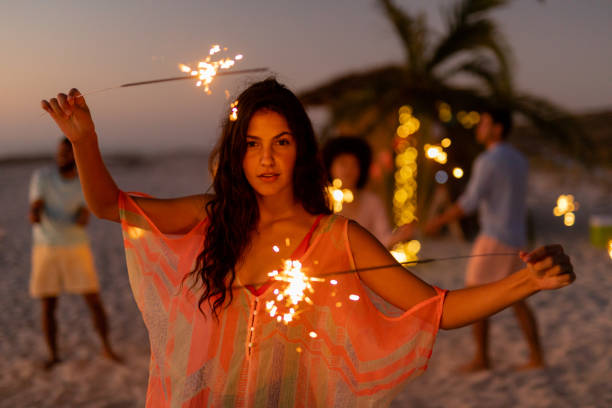 istock Multi-ethnic group of male and female dancing with firework stick 1262254052