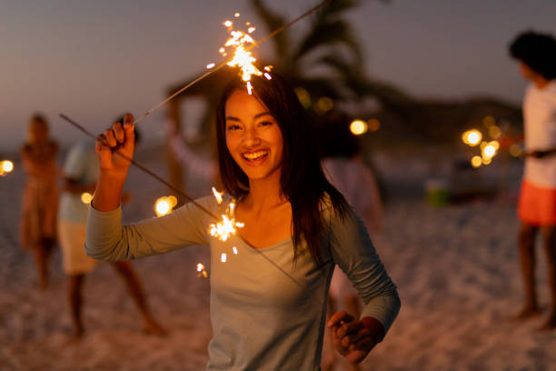 istock Multi-ethnic group of male and female dancing with firework stick 1262254066